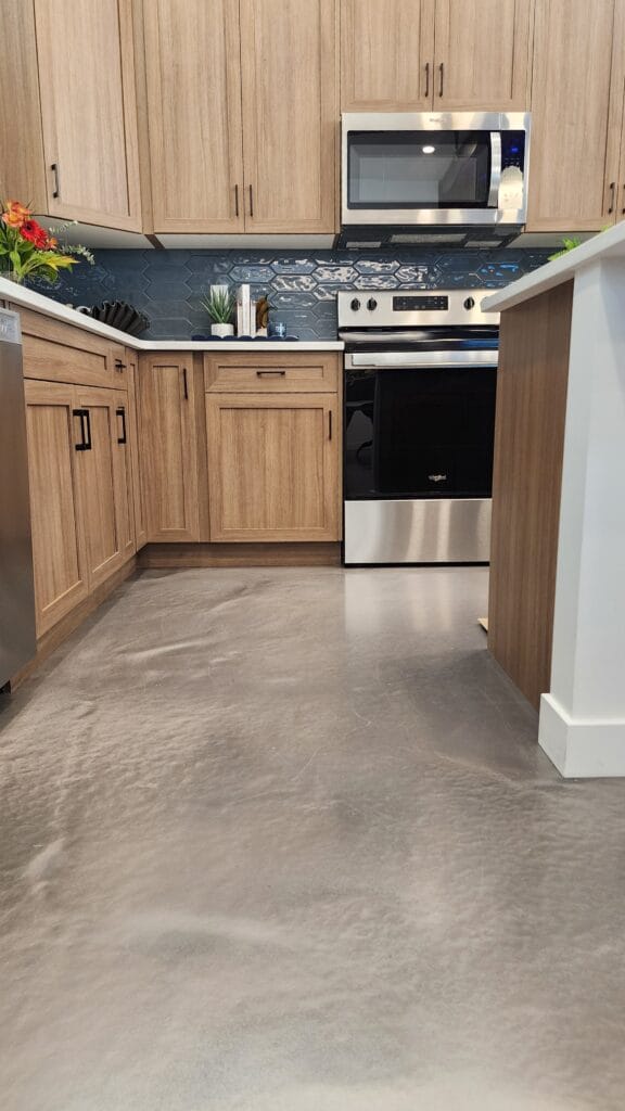 Metallic epoxy floor in Calgary kitchen with wood cabinetry and stainless steel appliances