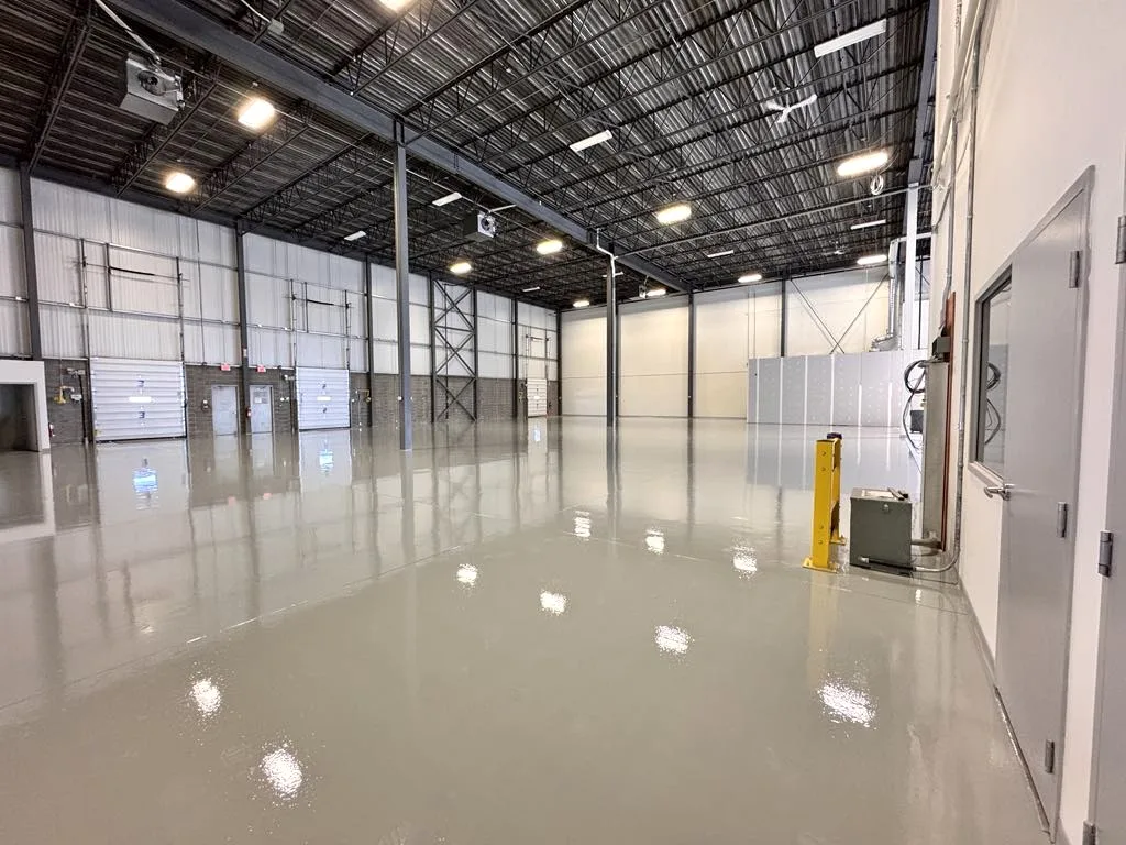 Large warehouse with seamless epoxy flooring in Foothills Industrial Park, Calgary, designed for industrial durability and heavy-duty use.