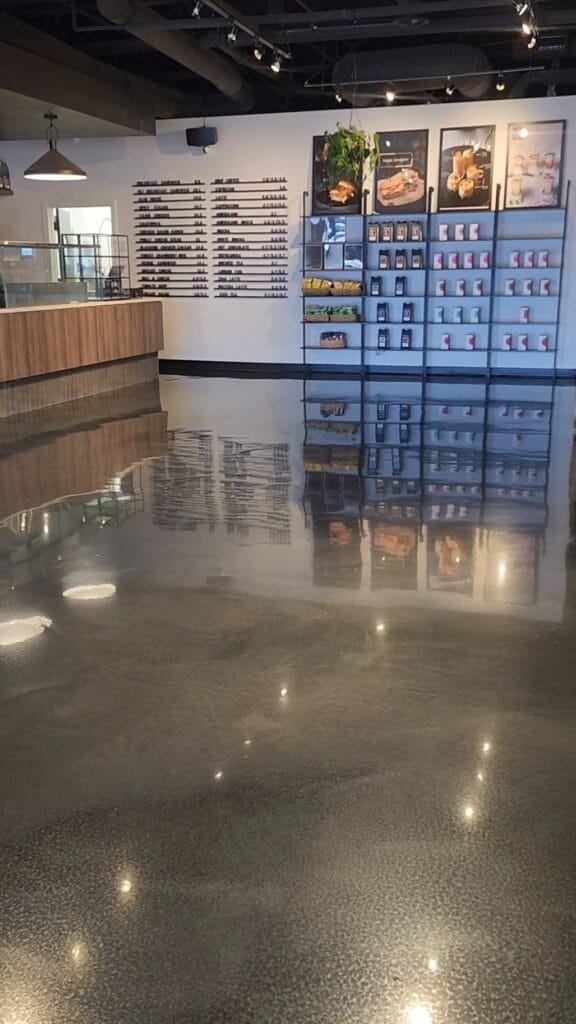 Metallic epoxy floor in a Calgary commercial retail space with custom high-gloss finish.