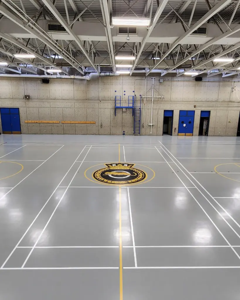 Epoxy flooring with line painting and brand logo in Calgary gym.